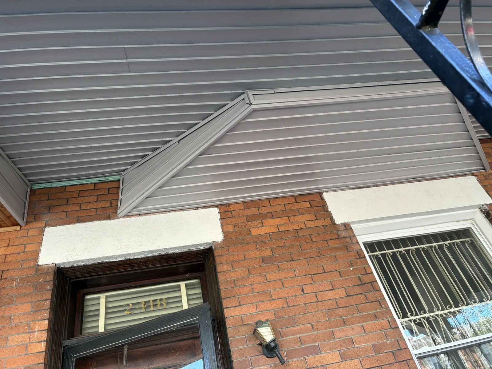 Gray ceiling covering fitted above the porch doorway and window.