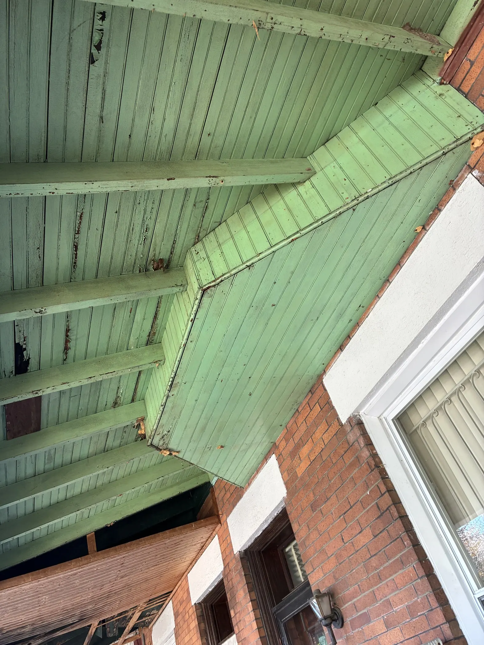 Green-painted porch boards before the ceiling covering was fitted.