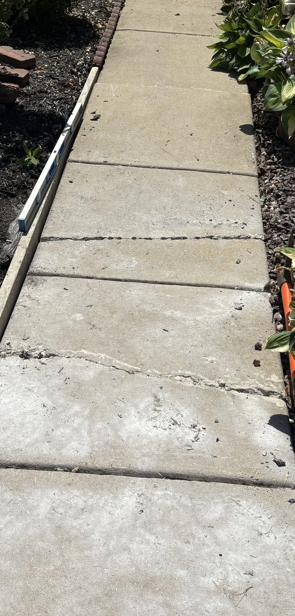 Cracked walkway slabs before replacement.