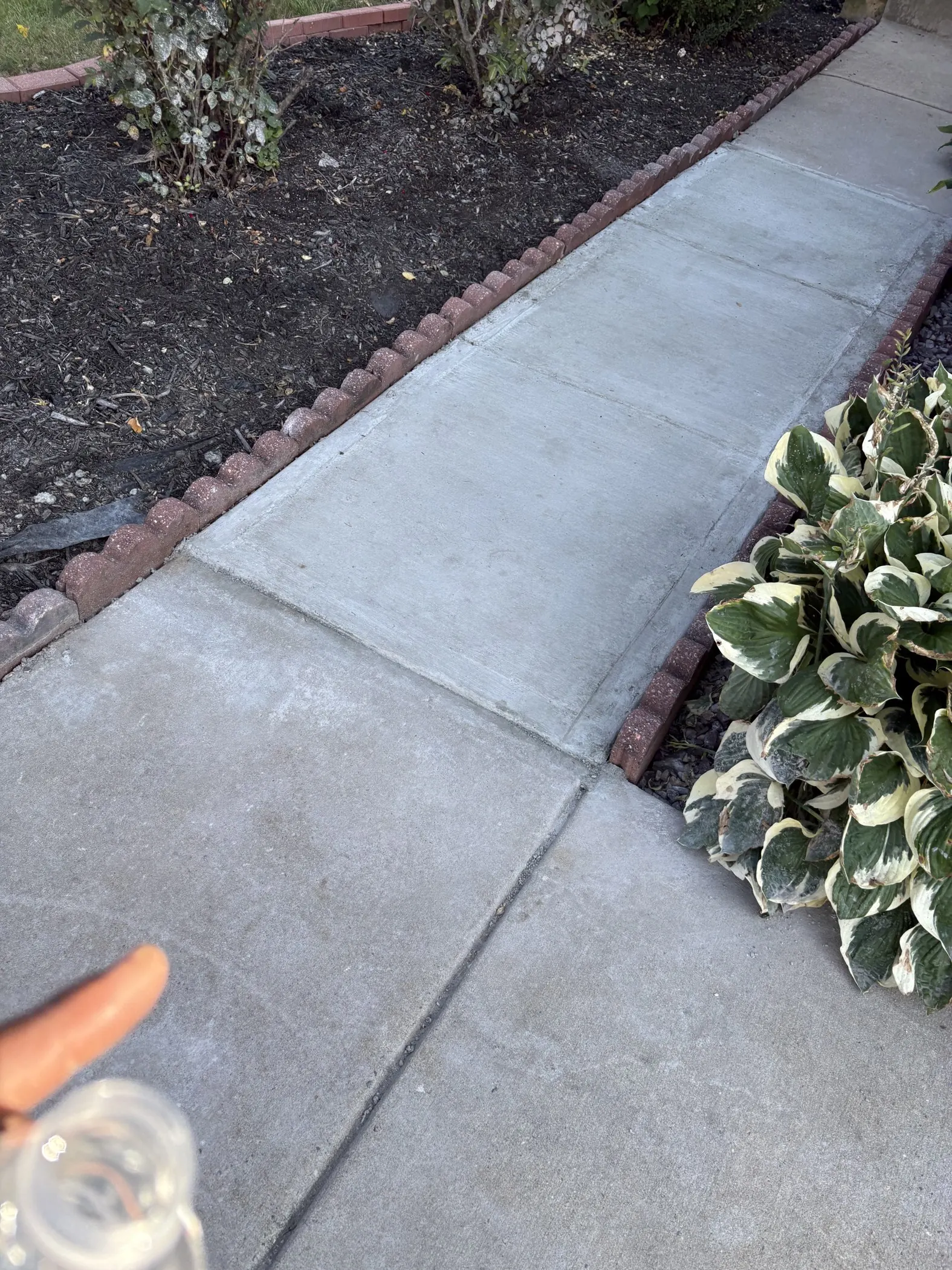 Replacement concrete in the center of the walkway.